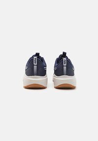 Navy athletic shoes with a mesh upper, white accents, and a rubber sole, featuring a rear pull tab for easy wear.
