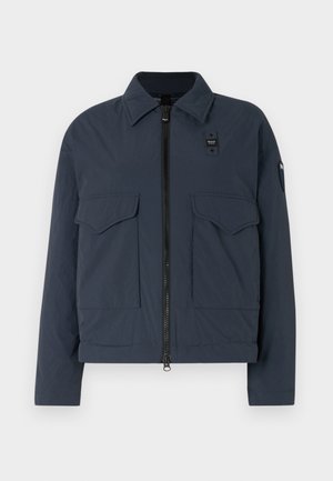 Navy blue jacket made of textured fabric, featuring a zipper closure, two front pockets, and a stand-up collar with a logo accent.