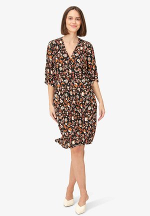 Black floral dress with a v-neck, short sleeves, and gathered waist. Features colorful flower patterns on a dark background.