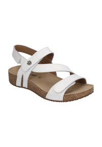 White sandal with cross straps made of smooth synthetic material, cork outsole, and a metal flower accent, featuring an open toe design.