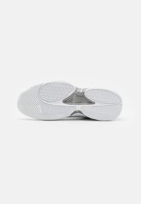 White athletic shoe sole with herringbone and hexagonal patterns; smooth gray accents in the midsole area, and durable rubber material.