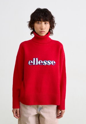 Rode gebreide trui met een hoge geribbelde kraag en een oversized pasvorm. Voorzien van blauw-wit "ellesse" logo op de voorkant. Geribbelde onderkant en manchetten.