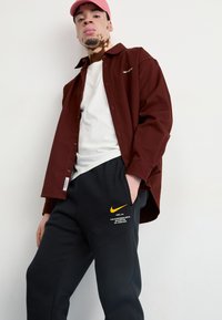 Nike Sportswear JOGGER   - Treniņtērpa apakšdaļas - black