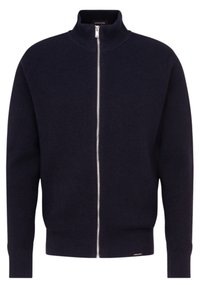 Pull zippé marine en tissu tricot côtelé, avec un col montant et des poignets ajustés, doté d'une petite étiquette de marque en bas à gauche.