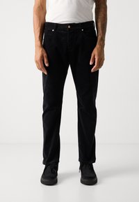 Black corduroy pants with a straight-leg design, featuring two front pockets, a zip fly, and a metal button closure. Soft texture and subtle sheen.