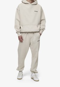 Pegador Jersey con capucha - beige
