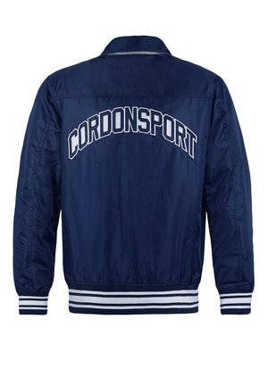 Marineblaue Bomberjacke mit satinierter Oberfläche, weißen gestreiften Bündchen und Saum sowie "CORDONSPORT" in weißen Buchstaben auf dem Rücken gestickt.