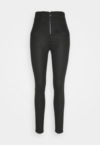 Jeans skinny de tiro alto en negro con cremallera frontal y bolsillos sobre un fondo blanco, presentados de frente y a longitud completa.