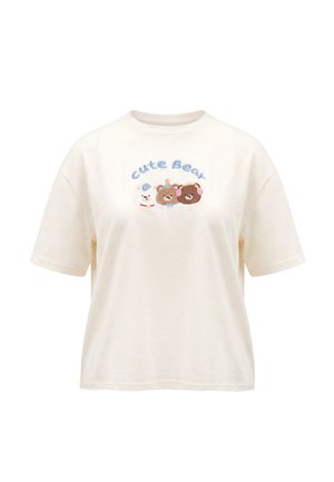 Beige T-shirt med teksten '"Cute Bear"' over tre tegneserie-bjørneansigter i hvid og brun, centreret på brystet.