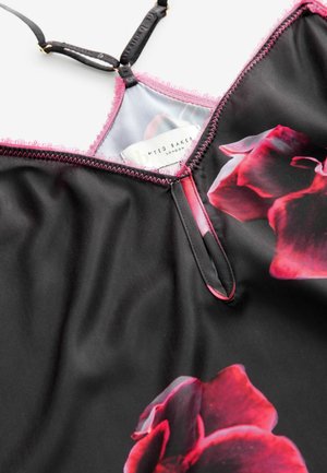 Czarna sukienka z czerwonymi wzorami kwiatowymi, regulowane czarne ramiączka oraz różowa falbanka przy dekolcie i otworach na ramiona.