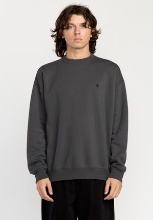 Gray crewneck sweatshirt made of soft fabric with ribbed cuffs and hem, featuring a small black logo on the chest and a relaxed fit.