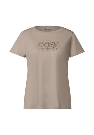 Beige bomull t-shirt med rund halsringning och korta ärmar. Har metallictryckt text "THE easy going" på framsidan. Slät textur.