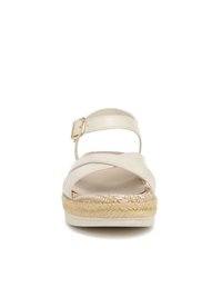 White leather sandal with cross straps and adjustable buckle. Features a textured woven midsole and flat rubber bottom.