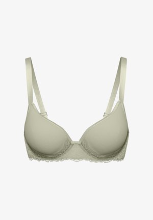 Soutien-gorge rembourré beige clair avec bretelles ajustables, bordure en dentelle le long de la bande, et un petit nœud décoratif au centre avant.