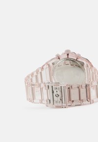 Klart pink ur med en sammenkædet plastrem, med en rund urkasse og sølvfarvet hardware, herunder to sideknapper og en spænde.