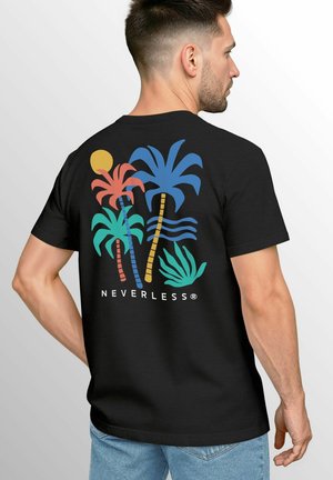 A man stands with his back to the camera, wearing a black t-shirt featuring colorful palm trees and the word "NEVERLESS" below.