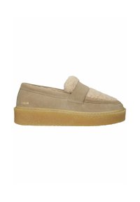 Beige suede loafer with thick gum sole and fluffy shearling-covered top panel, side gold logo text, slip-on style.