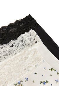 Sada tří elastických pásků v černé, bílé a květinové vzorované látce, s krajkovými detaily na horním okraji každého pásku.