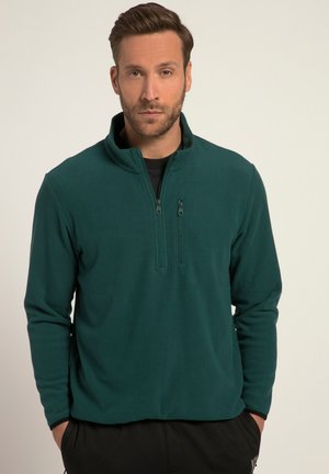 Mørkegrøn fleece-pullover med halv lynlås krave, lange ærmer og en blød tekstur. Har to lynlåslommer på forsiden.