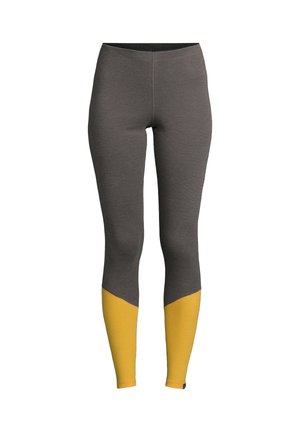 Leggings gris au design ajusté, avec un accent jaune au niveau des jambes inférieures et un matériau texturé au niveau des chevilles.