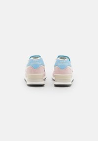 Pink and blue New Balance sneakers with a suede and mesh upper, featuring a cushioned sole and logo detail on the back.