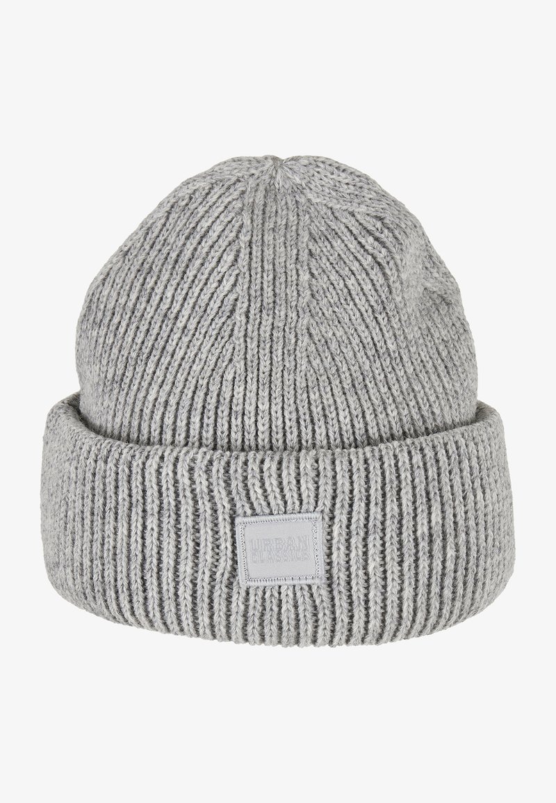 Gray knitted beanie hat with ribbed texture, featuring a folded cuff and a small rectangular label with embossed text on the front.