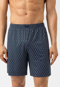 Marineblauwe zwemshorts met een herhalend wit dierenpatroon, elastische tailleband en een relaxte pasvorm. Gemaakt van lichtgewicht, gladde stof.