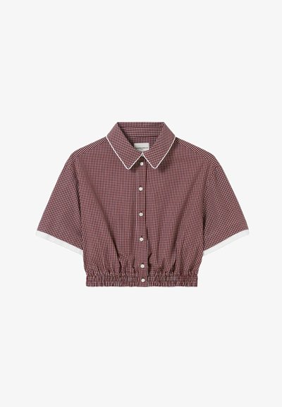 Maglietta corta a motivo check bordeaux con colletto e polsini bianchi. Presenta un elastico in vita e chiusura a bottoni frontale. Tessuto morbido.