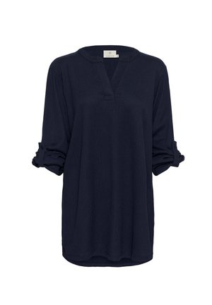 Blouse bleu marine à manches longues avec un décolleté en V, en tissu texturé, manches retroussées et coupe décontractée, dotée de fentes latérales et sans motifs visibles.