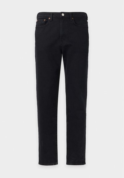 Jean noir droit avec fermeture avant par bouton et zip, passants de ceinture et design à cinq poches sur fond clair uni.