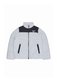 Witte fleecejas met zwart schouderpaneel en ritssluiting. Voorzien van twee zijzakken en een Reebok-logo op de borst. Zachte textuur.