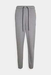 Grå sweatpants av mjukt tyg, med resårmidja och dragsko samt en tapered design. Liten logotypdetalj på sidan.