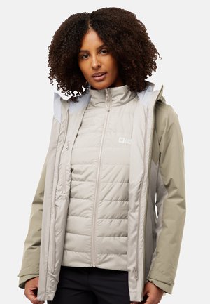 Lightweight, grey puffer jacket with a zip closure and high collar, layered with a weather-resistant outer shell featuring a beige accent.