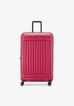 Hartschalen-Koffer in strahlendem Pink, mit vertikalen Rillen, einem ausziehbaren Griff und vier Rollen für Mobilität. Markenlogo auf der Vorderseite.