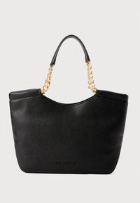 Black leather tote bag with textured finish, curved top, and dual handles featuring a gold chain accent. Logo embossed on front.