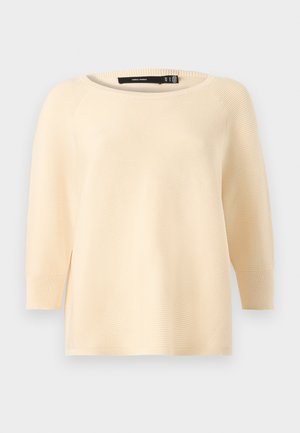 Light beige knitted sweater with a wide neckline, three-quarter length sleeves, ribbed texture, and side slits at the hem.