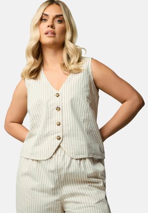 Sleeveless cream top with vertical stripes, V-neckline, six brown buttons, and a curved hem, made from textured fabric. Paired with matching bottoms.