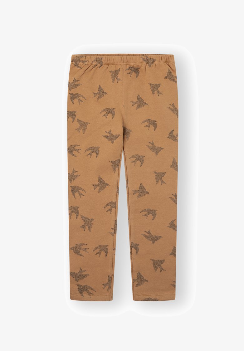 Leggings color marrón hechos de tela suave, con un patrón negro de aves repetido, y una cintura elástica para mayor comodidad.