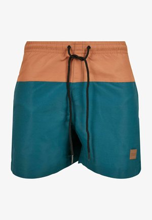 Pantaloni da bagno con una cintura marrone e corpo in teal. Presentano una chiusura con cordoncino e un piccolo logo sulla parte inferiore destra.