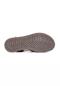 Suola della scarpa con un design robusto e texture. Materiale in gomma marrone presenta motivi di trazione profondi e impugnature esagonali per stabilità su vari terreni.