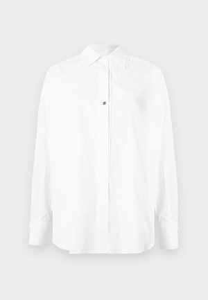 White long-sleeve shirt made of smooth fabric, featuring a pointed collar, button front, and a small logo detail near the center.