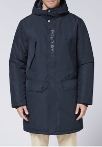 Navy blue parka jacket featuring a zip and snap closure, two front pockets, and "POLO SYLT" logo in white along the front. Textured fabric.