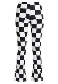 Black and white checkered flared leggings made of stretchy fabric, featuring a high waist and pattern of alternating squares.