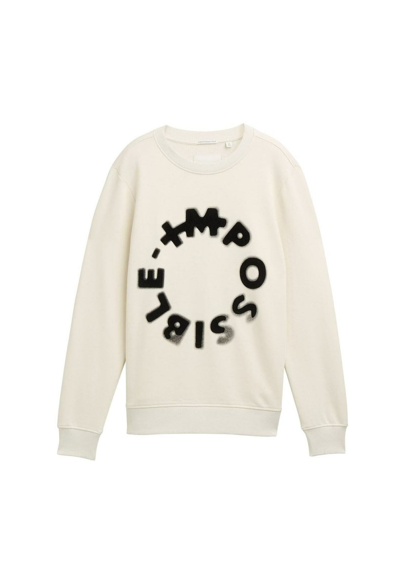 Sudadera hecha de suave tela color crema con un motivo circular que presenta letras negras que deletrean "IMPOSIBLE" en diferentes fuentes y tamaños.