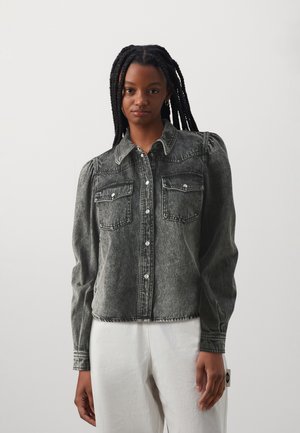 Denimhemd in vervaagd zwart met een knoopsluiting aan de voorkant, puntige kraag en twee borstzakken. Heeft pofmouwen en zichtbare stikdetails.