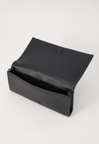Black leather clutch bag with a smooth texture, open design, and rounded snap closure. Features a spacious interior for easy access.