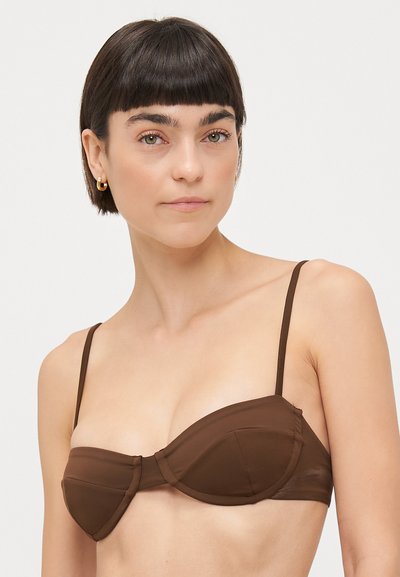 Brown bikini top with underwire, padded cups, and thin adjustable straps. Smooth texture; no visible patterns or hardware details.