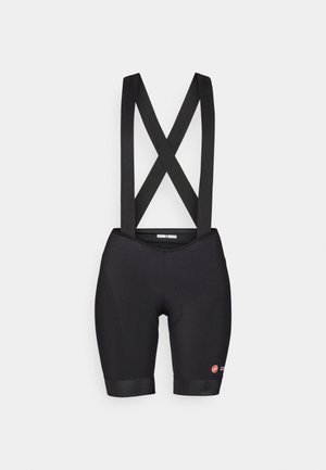 Black cycling shorts with elastic straps, featuring a padded seat area and contrasting logo on the lower leg. Smooth, stretchy fabric.
