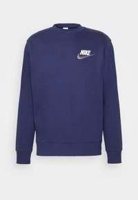 Mörkblå långärmad tröja med rund hals och vit Nike-logotyp samt swoosh på vänster bröst, ribbade mudd och nederkant.