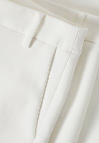 Weiße maßgeschneiderte Hose aus glattem Stoff, mit flachem Vorderteil, Seitentaschen und sauberem Finish mit einem dezenten Glanz.